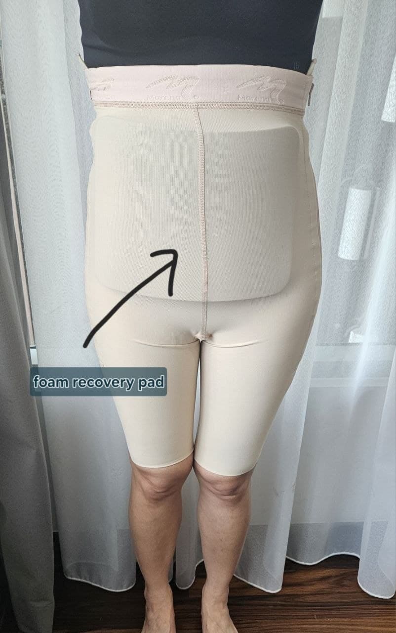 Foam recovery pad worn under a postoperative compression garment after liposuction to help distribute pressure evenly